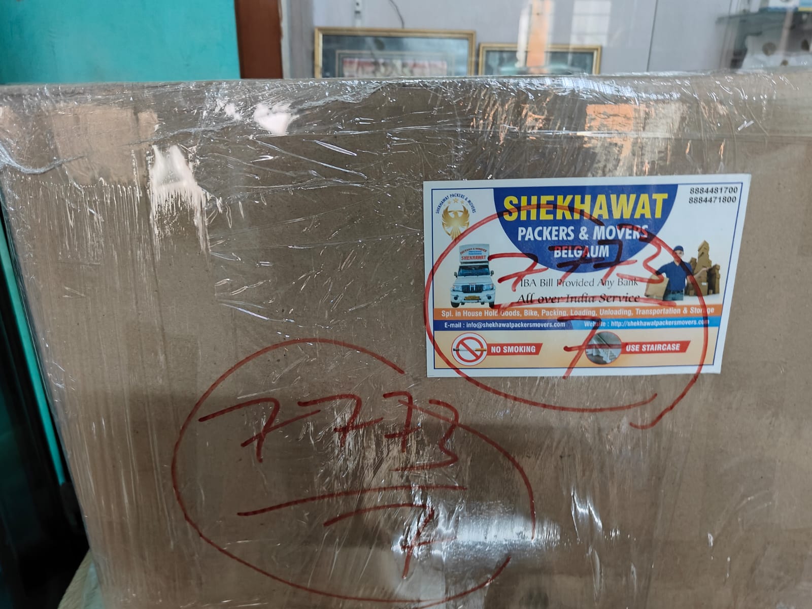 Shekhawat Packers and Movers Belgaum - carton box with company sticker and staircase handling instructions